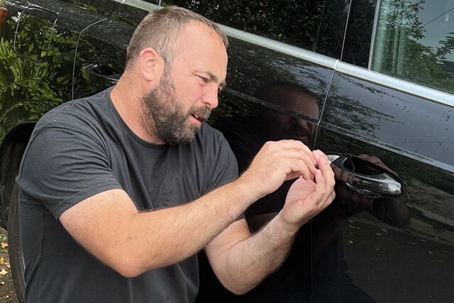 Wolverhampton Car Locksmith Picking The Lock of a Black Car