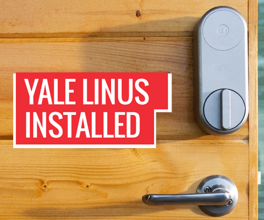 Silver Yale Linus Smart Lock Installed On Wooden Door